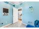 Bright bedroom with light-blue walls that leads to the kitchen area at 230 Addison Cottage Way, Murrells Inlet, SC 29576