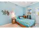 Cozy bedroom with bright blue walls and a bed with decorative starfish comforter set at 230 Addison Cottage Way, Murrells Inlet, SC 29576
