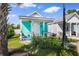 Charming turquoise house with a cozy front porch, garden, and white picket fence at 230 Addison Cottage Way, Murrells Inlet, SC 29576