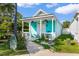 Charming turquoise house with a cozy front porch, ceiling fans, and landscaped garden at 230 Addison Cottage Way, Murrells Inlet, SC 29576