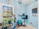 Bright home office featuring a stylish desk, bar stool, and plant-filled window, creating a serene workspace at 230 Addison Cottage Way, Murrells Inlet, SC 29576