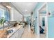 Well-lit galley kitchen featuring white cabinetry, granite countertops, and modern stainless steel appliances at 230 Addison Cottage Way, Murrells Inlet, SC 29576