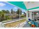 Inviting screened porch overlooking a backyard; includes seating and bright decor at 230 Addison Cottage Way, Murrells Inlet, SC 29576