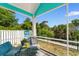 Relaxing screened porch with comfortable seating and lush green view at 230 Addison Cottage Way, Murrells Inlet, SC 29576