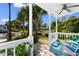 Inviting porch with white railings, ceiling fan, seating, and views of the lush surroundings at 230 Addison Cottage Way, Murrells Inlet, SC 29576