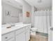 Well-lit bathroom featuring white cabinets, a framed mirror, and shower with a curtain at 232 Je Edward Dr. # 19, Myrtle Beach, SC 29588