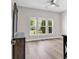 Light-filled bedroom boasts hardwood floors and multiple windows that offer natural light and an airy atmosphere at 232 Je Edward Dr. # 19, Myrtle Beach, SC 29588