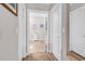 Hallway leading to a bathroom with tiled floors and white cabinets at 232 Je Edward Dr. # 19, Myrtle Beach, SC 29588