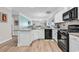 Bright open kitchen with granite countertops, stainless steel appliances, and a view into the adjacent living area at 232 Je Edward Dr. # 19, Myrtle Beach, SC 29588