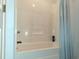 Bathroom features a bathtub with white surround and blue shower curtain at 250 Nature Trail, Little River, SC 29566