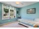 Bright bedroom with coastal decor, ceiling fan, and window overlooking the front yard at 250 Nature Trail, Little River, SC 29566