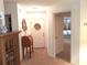Inviting entryway with neutral carpet, white walls, and decorative wreath on the front door at 250 Nature Trail, Little River, SC 29566