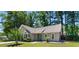 Inviting home with a manicured lawn, complemented by mature trees and a delightful turquoise front door at 250 Nature Trail, Little River, SC 29566