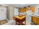 Kitchen with oak cabinets, white appliances, and an island at 250 Nature Trail, Little River, SC 29566