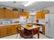 Kitchen with oak cabinets, white countertops, and an island at 250 Nature Trail, Little River, SC 29566