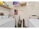 Bright laundry room with washer, dryer, shelving and storage space at 250 Nature Trail, Little River, SC 29566