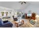 Bright living room featuring a vaulted ceiling, an adjacent dining area, and sliding door access to the backyard at 250 Nature Trail, Little River, SC 29566