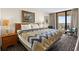 Cozy bedroom features modern patterned bedding, balcony access and great natural light at 2500 N Ocean Blvd. # 601, Myrtle Beach, SC 29577