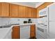 Bright kitchen with white appliances and wood cabinetry, perfect for everyday cooking at 2500 N Ocean Blvd. # 601, Myrtle Beach, SC 29577