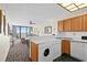 Convenient kitchen including washer and dryer, with views of the ocean and the living space at 2500 N Ocean Blvd. # 601, Myrtle Beach, SC 29577