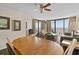 Open-plan living area features an ocean view, ceiling fan, dining table, and comfortable furnishings at 2500 N Ocean Blvd. # 601, Myrtle Beach, SC 29577