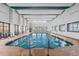 Indoor pool area with tables and chairs, doors to the outside, and clear blue water at 2500 N Ocean Blvd. # 601, Myrtle Beach, SC 29577