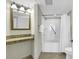 Bathroom featuring a combined tub and shower, a decorative mirror, and a granite countertop at 2504 N Ocean Blvd. # 2030, Myrtle Beach, SC 29577