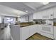 Bright kitchen featuring granite counters, white appliances, and an open layout that flows seamlessly into the living area at 2504 N Ocean Blvd. # 2030, Myrtle Beach, SC 29577