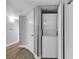 Hallway view of stacked washer and dryer in closet with white doors and trim at 2504 N Ocean Blvd. # 2030, Myrtle Beach, SC 29577
