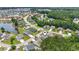 Scenic aerial view of a residential community with a lake and lush greenery, showcasing the neighborhood's layout at 278 Carolina Crossing Blvd., Little River, SC 29566