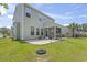 View of back of house with an expansive lawn and screen door porch at 278 Carolina Crossing Blvd., Little River, SC 29566