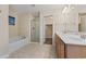 Bright bathroom featuring a soaking tub, glass enclosed shower, and double sink vanity with wood cabinets at 278 Carolina Crossing Blvd., Little River, SC 29566