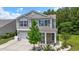 Charming two-story home with neutral siding, stone accents, a manicured lawn, and a two-car garage at 278 Carolina Crossing Blvd., Little River, SC 29566