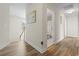 Hallway with wood floors that leads to a bathroom and the second floor at 278 Carolina Crossing Blvd., Little River, SC 29566