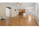 Open-concept living room showcasing hardwood floors, arched doorway, and seamless flow to the kitchen at 278 Carolina Crossing Blvd., Little River, SC 29566