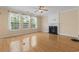 Bright and airy living room with hardwood floors, a fireplace, and plenty of natural light from the large windows at 278 Carolina Crossing Blvd., Little River, SC 29566