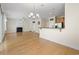 Open-concept living room, dining room, and kitchen featuring hardwood floors and a fireplace at 278 Carolina Crossing Blvd., Little River, SC 29566