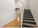 Bright foyer featuring hardwood floors and a staircase with wooden handrail and carpeted treads at 278 Carolina Crossing Blvd., Little River, SC 29566