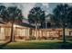 Expansive backyard with a covered patio, lush lawn, mature trees, and outdoor dining area at 2790 Fowler Rd., Loris, SC 29569