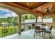 Stunning balcony view overlooking lush landscaping and serene lake with seating, perfect for relaxation at 2790 Fowler Rd., Loris, SC 29569