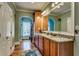 Bathroom with granite counters, double sinks, wood floors and a closet with window at 2790 Fowler Rd., Loris, SC 29569