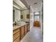 Bathroom with granite countertops, light oak cabinets, a large mirror and hardwood floors at 2790 Fowler Rd., Loris, SC 29569
