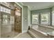 Spa-like bathroom featuring a glass shower and a jacuzzi tub with bright windows at 2790 Fowler Rd., Loris, SC 29569