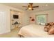 Bright bedroom with a ceiling fan, neutral walls, plush carpet, and large window to let in light at 2790 Fowler Rd., Loris, SC 29569