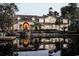 Charming home reflected in the water, featuring a covered entrance, dormer windows, and lush landscaping at 2790 Fowler Rd., Loris, SC 29569