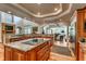 Gourmet kitchen with granite countertops, a center island, custom cabinetry, and access to multiple living spaces at 2790 Fowler Rd., Loris, SC 29569