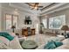 Spacious living room with tray ceiling, large windows, plush seating, and a flatscreen television at 2790 Fowler Rd., Loris, SC 29569