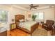 Cozy main bedroom featuring hardwood floors, a ceiling fan, and a bright window at 2790 Fowler Rd., Loris, SC 29569