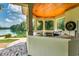 Outdoor kitchen with countertop seating, a grill, a stained wood ceiling and a water view at 2790 Fowler Rd., Loris, SC 29569
