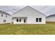 Backyard view of a white house featuring a grassy lawn and covered porch at 307 Dunlin Pl, Conway, SC 29526